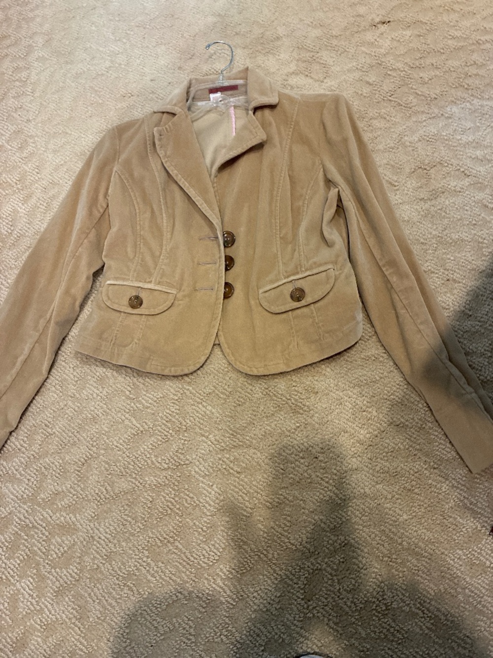 Woman’s short tan jacket.
